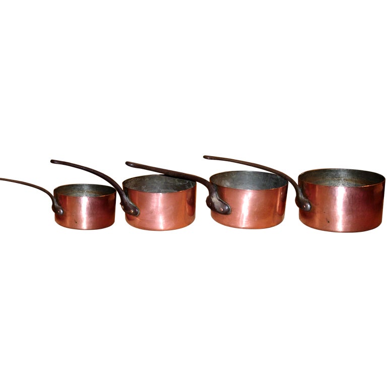 Set of four iron-and-copper pots, 19th century
